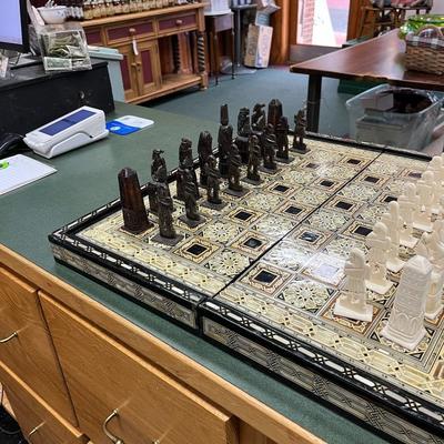 Sale Photo Thumbnail #842: Mosaic style inlaid Chess Set with Mother of Pearl.  The set includes 32 chess pieces, divided into dark and light colors.  One piece is broken (See Photo).  Has Backgammon on the flip side.