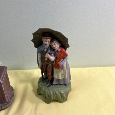 2 Porcelain Bisque Figurines; Stock Broker and Old Man & Woman w/Umbrella. 