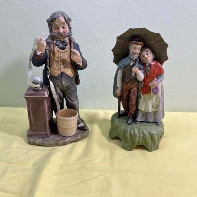 2 Porcelain Bisque Figurines; Stock Broker and Old Man & Woman w/Umbrella. 