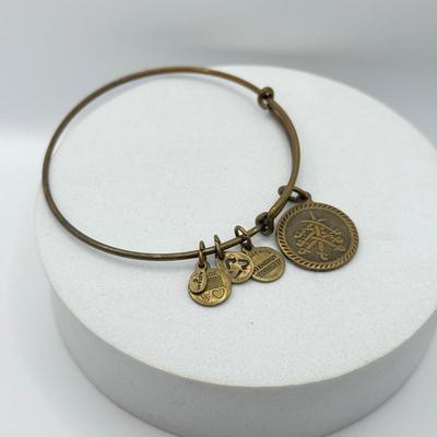 LOT 90J: Alex and Ani Charm Bracelets: Capricorn, Young & Strong, Paw Print & More