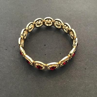 Very nice gold tone, red rhinestone stretchy bracelet