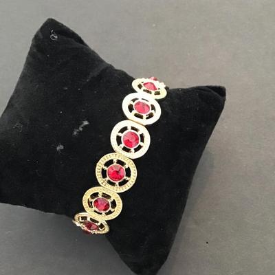 Very nice gold tone, red rhinestone stretchy bracelet