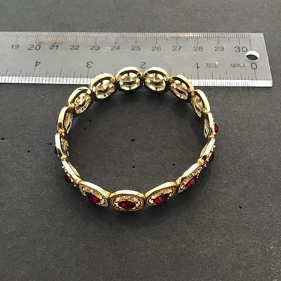 Very nice gold tone, red rhinestone stretchy bracelet