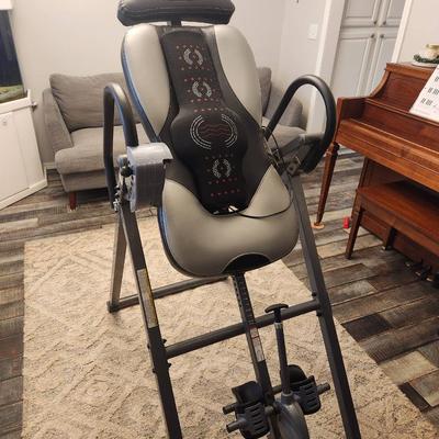 Sale Photo Thumbnail #20: Innova inversion therapy table featuring adjustable lumbar support and a six-position height-adjustment system. The table is made from a durable steel frame with comfortable padded backrest and ankle holders. Includes ergonomic handles and a safety strap 