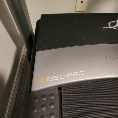 Sale Photo Thumbnail #12: NordicTrack C 950 Pro treadmill featuring a digital display with iFit compatibility. Includes speed and incline controls, multiple workout modes, and handgrip heart rate sensors. Designed with a durable belt and sturdy frame, suitable for home exercise. E