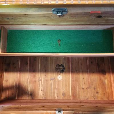 Sale Photo Thumbnail #18: Lane cedar chest featuring a wood veneer exterior with chevron pattern detailing on the lid and sides. Interior lined with cedar wood, includes green felt-lined storage compartments for smaller items. Retains Lane branding and authenticity markings. Vinta