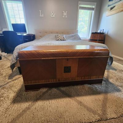 Sale Photo Thumbnail #14: Lane cedar chest featuring a wood veneer exterior with chevron pattern detailing on the lid and sides. Interior lined with cedar wood, includes green felt-lined storage compartments for smaller items. Retains Lane branding and authenticity markings. Vinta
