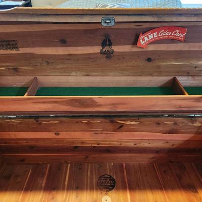 Sale Photo Thumbnail #17: Lane cedar chest featuring a wood veneer exterior with chevron pattern detailing on the lid and sides. Interior lined with cedar wood, includes green felt-lined storage compartments for smaller items. Retains Lane branding and authenticity markings. Vinta
