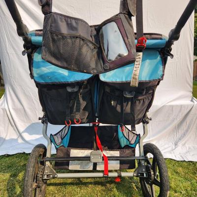 Sale Photo Thumbnail #29: BOB Gear Revolution SE Duallie double jogging stroller, featuring a durable aluminum frame and fabric seats. Includes a front swivel locking wheel for improved maneuverability, adjustable canopies, and 5-point safety harnesses for both seats. Equipped wit