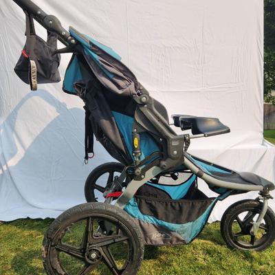 Sale Photo Thumbnail #28: BOB Gear Revolution SE Duallie double jogging stroller, featuring a durable aluminum frame and fabric seats. Includes a front swivel locking wheel for improved maneuverability, adjustable canopies, and 5-point safety harnesses for both seats. Equipped wit