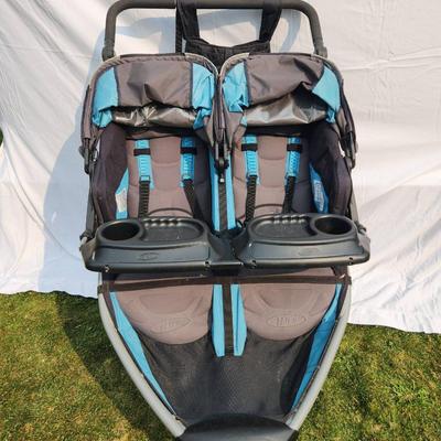 Sale Photo Thumbnail #26: BOB Gear Revolution SE Duallie double jogging stroller, featuring a durable aluminum frame and fabric seats. Includes a front swivel locking wheel for improved maneuverability, adjustable canopies, and 5-point safety harnesses for both seats. Equipped wit