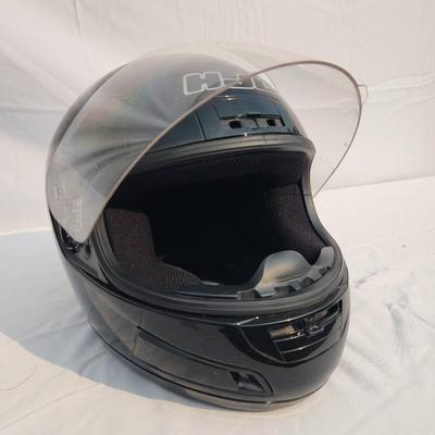 Sale Photo Thumbnail #40: HJC black full-face motorcycle helmet featuring a clear visor and internal padded lining. The helmet is DOT certified, indicating it meets safety standards for motorcycles. The outer shell shows light wear. Size and specific model details are not specifie