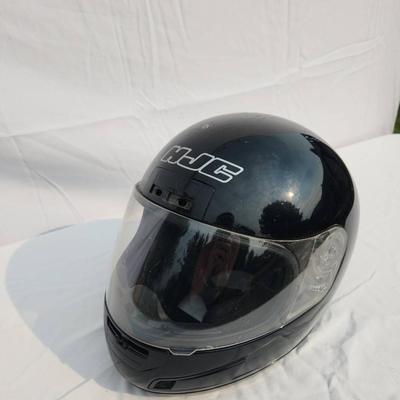 Sale Photo Thumbnail #38: HJC black full-face motorcycle helmet featuring a clear visor and internal padded lining. The helmet is DOT certified, indicating it meets safety standards for motorcycles. The outer shell shows light wear. Size and specific model details are not specifie