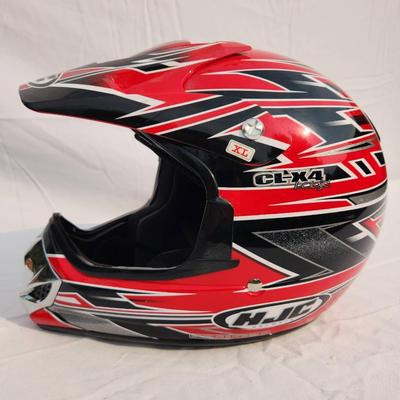 Sale Photo Thumbnail #43: HJC CL-XY1 motocross helmet featuring bold red and black graphic designs. Size XL, constructed for motocross and off-road use. Includes a visor for sun protection, interior padding for comfort, and a durable outer shell. Appears in good condition with no 