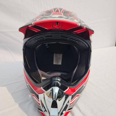 Sale Photo Thumbnail #42: HJC CL-XY1 motocross helmet featuring bold red and black graphic designs. Size XL, constructed for motocross and off-road use. Includes a visor for sun protection, interior padding for comfort, and a durable outer shell. Appears in good condition with no 