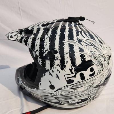 Sale Photo Thumbnail #47: 509 full-face off-road helmet featuring a bold black and white graphic design. Includes an adjustable visor, vented front for breathability, soft interior padding for comfort, and secure chin strap. Designed for off-road terrains and durable protection. S