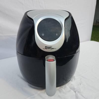 Sale Photo Thumbnail #53: Power Air Fryer XL digital air fryer with a 5.3-quart capacity, designed for frying, baking, roasting, and reheating. Features a digital control panel with temperature and cooking presets. Comes in black finish with a silver accent panel. Includes basket 