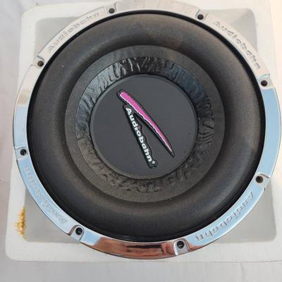 Sale Photo Thumbnail #59: Audiobahn AW101T 10-inch car subwoofer, featuring a dual 4-ohm voice coil configuration. The unit includes its original box with visible wear and signs of age. The subwoofer is housed in its protective packaging and exhibits a chrome design and branding o