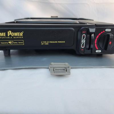 Sale Photo Thumbnail #62: Home Power HP-1000 portable butane gas range from the Total Kitchen Collection. Features a durable metal body with a gas burner and adjustable flame control dial. Includes a hard plastic carrying case for easy portability and storage. Designed for outdoor