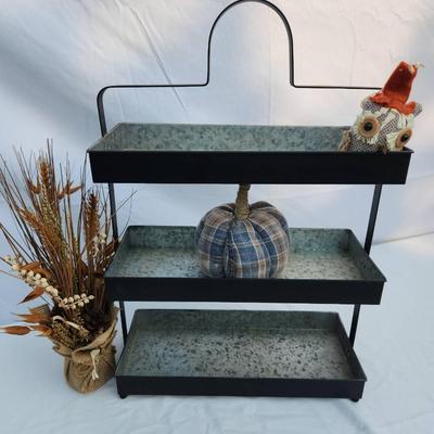 Sale Photo Thumbnail #63: Three-tier tray stand constructed from galvanized metal with a black finish and sturdy metal frame. Features a carrying handle at the top for easy portability. Suitable for kitchen, decoration, or organizational purposes. Includes three spacious rectangul