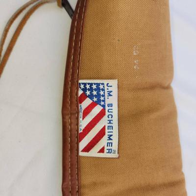Sale Photo Thumbnail #71: J.M. Buchheimer gun case constructed with durable canvas material, leather trim, and reinforced leather handles. Features a soft interior lining to ensure firearm protection and a zippered closure. Branded with the J.M. Buchheimer tag featuring an America