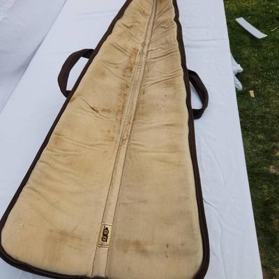 Sale Photo Thumbnail #73: Canvas rifle case featuring a camouflage pattern with leather reinforcement accents. Includes dual carrying handles for convenience and a zipper closure system. Interior is lightly padded with signs of wear, including discoloration and potential stains. E
