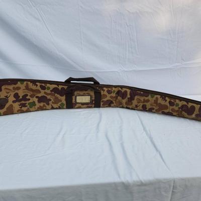 Sale Photo Thumbnail #72: Canvas rifle case featuring a camouflage pattern with leather reinforcement accents. Includes dual carrying handles for convenience and a zipper closure system. Interior is lightly padded with signs of wear, including discoloration and potential stains. E