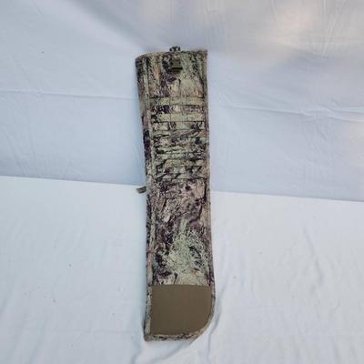 Sale Photo Thumbnail #75: Eberlestock rifle scabbard featuring the 'Hide Open' design with camouflage pattern. Constructed with durable materials and includes a secure clip closure mechanism. Designed for efficient rifle transport and storage in outdoor settings. Specific dimensio