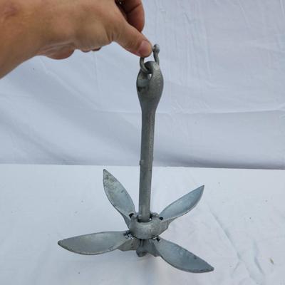 Sale Photo Thumbnail #87: Galvanized folding anchor featuring four flukes and a locking mechanism for secure use. Designed for small boats, kayaks, or as a portable anchoring solution. Folding design allows for compact storage. Constructed of durable galvanized metal to resist cor