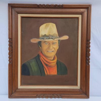 Sale Photo Thumbnail #89: Framed portrait painting depicting a cowboy wearing a tan hat, red scarf, and dark vest. Signed by the artist 'Janet' on the lower right corner. The painting is done on canvas and is framed in a decorative wooden frame with a carved design. Back of the fr