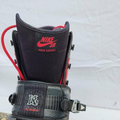 Sale Photo Thumbnail #98: Ride snowboard featuring bold red and black graphics on both sides. Comes equipped with Nike SB Vapen snowboard boots in red and black colorway, size 13 (US), and matching bindings. The snowboard showcases an intricate skull and rose design on one side an