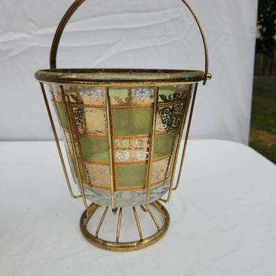 Sale Photo Thumbnail #116: Mid-century drinkware set featuring green and gold checkered glass designs. The set includes a group of tall glasses in a brass wire carrier with a wooden handle, a smaller set of lowball glasses in a brass carrier with wooden handles, and an additional i