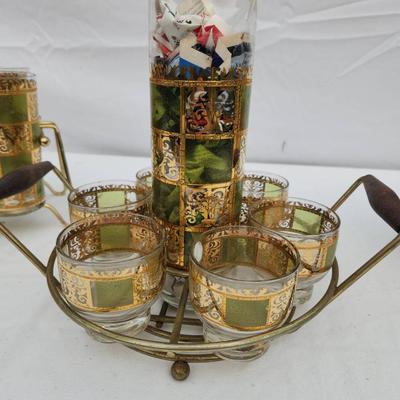 Sale Photo Thumbnail #117: Mid-century drinkware set featuring green and gold checkered glass designs. The set includes a group of tall glasses in a brass wire carrier with a wooden handle, a smaller set of lowball glasses in a brass carrier with wooden handles, and an additional i