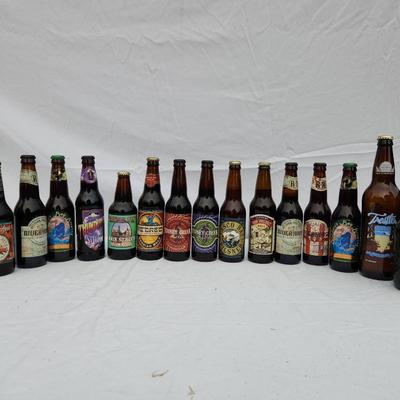 Sale Photo Thumbnail #118: Craft beer bottles consisting of various brands and labels. The collection includes both sealed and possibly empty bottles (condition unspecified), with labels featuring a wide range of designs and themes. Some bottles have swing-top caps and are from sma