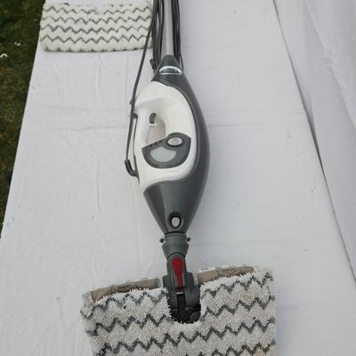 Sale Photo Thumbnail #120: Shark Professional steam mop with a gray and white body, featuring a steam control button for adjustable steam settings. Includes a detachable cleaning pad and cord for power. Designed for sanitizing and deep cleaning hard floors. Comes with an additional