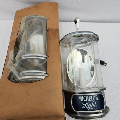 Sale Photo Thumbnail #123: Michelob Light promotional hanging lantern-style light featuring a chrome body with glass panels, an internal candle-shaped bulb, and branded 'Michelob Light' signage. Includes original packaging. Designed as a decorative electric light fixture. In good c