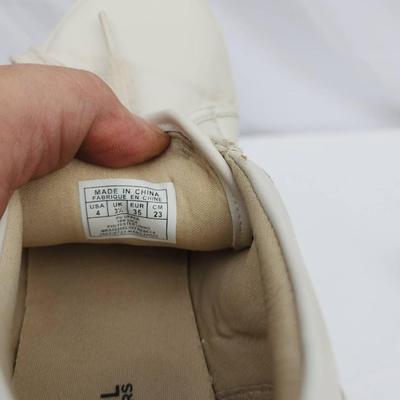 Sale Photo Thumbnail #130: Michael Kors women's lace-up sneakers with monogram print. Tagged as size US 5.5 (EU 35, UK 3). Features beige canvas and leather with gold-tone eyelets. Moderate wear visible on soles and minor scuffs on toes. Made in China.