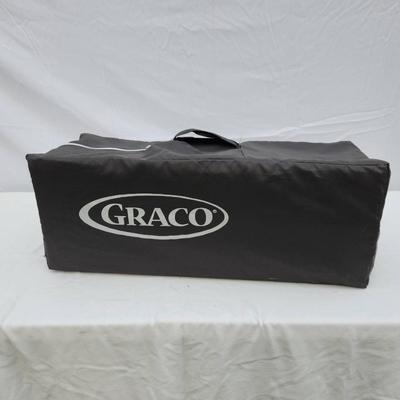 Sale Photo Thumbnail #145: Graco Pack 'n Play portable playard featuring a mesh design for easy ventilation and visibility. Includes a sturdy frame with wheels for easy mobility and a patterned fabric upper section. Comes with a convenient carrying bag for transportation and storag