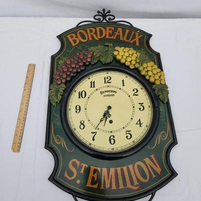 Sale Photo Thumbnail #153: Bordeaux St. Emilion decorative wall clock, featuring a wrought iron frame and a wine-themed design with 3D grape clustering details in red and yellow colors. The clock face displays 'Bordeaux Import' and numbered hours, with hour and minute hands. Measur