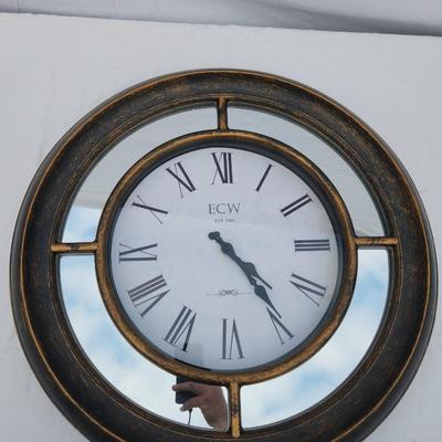 Sale Photo Thumbnail #162: K&W wall clock featuring a distressed metallic frame with an antique-style finish. The clock face displays large Roman numerals and black spade hands for easy readability. Ideal for wall mounting, the clock is battery-operated (batteries not included). No