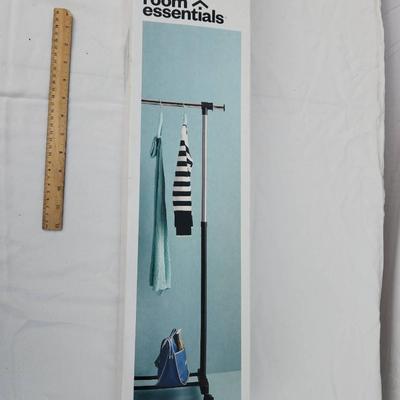 Sale Photo Thumbnail #180: Room Essentials adjustable garment rack, as shown in original packaging. The item is designed to support hanging garments, offering an extendable design for customizable height and width. Box shows some wear but is intact. Includes instructions and all co