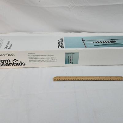 Sale Photo Thumbnail #181: Room Essentials adjustable garment rack, as shown in original packaging. The item is designed to support hanging garments, offering an extendable design for customizable height and width. Box shows some wear but is intact. Includes instructions and all co