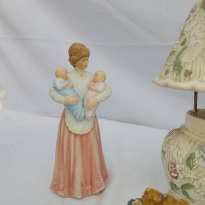 Sale Photo Thumbnail #207: Two decorative mother-and-child figurines, one bear figurine holding flowers, and a small table lamp with a floral-patterned shade. The figurines appear to be made of ceramic or resin, showcasing detailed craftsmanship. The ruler shown provides a size ref