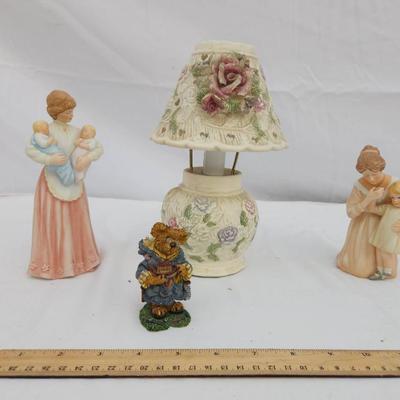 Sale Photo Thumbnail #206: Two decorative mother-and-child figurines, one bear figurine holding flowers, and a small table lamp with a floral-patterned shade. The figurines appear to be made of ceramic or resin, showcasing detailed craftsmanship. The ruler shown provides a size ref
