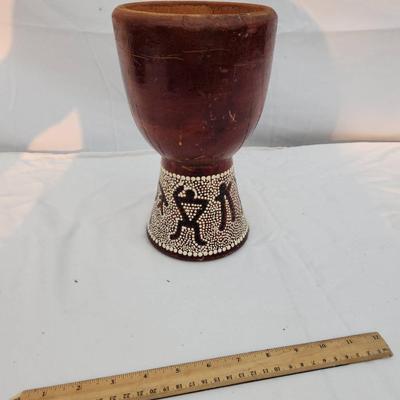Sale Photo Thumbnail #209: A handcrafted wooden goblet featuring a smooth wooden bowl and a beaded base adorned with decorative patterns. The intricate beadwork showcases figures and geometric designs, adding a striking detail. The goblet shows signs of prior use, with visible wear
