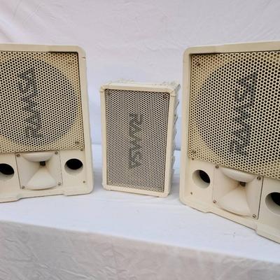 Sale Photo Thumbnail #217: Three white Panasonic speaker systems, model WA-260-MW. Includes two larger speakers and one smaller unit, all featuring mesh grills and labeled with parallel input options. Some signs of wear or discoloration may be present. Suitable for professional or 