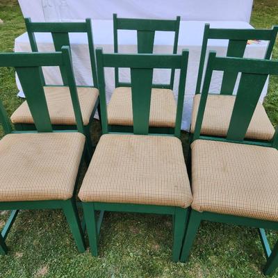 Sale Photo Thumbnail #250: Six wooden dining chairs, painted green, featuring a simple slat-back design. Each chair includes an upholstered seat covered in a checked beige fabric. Overall construction appears sturdy, and the upholstery is consistent across all chairs. Ideal for din