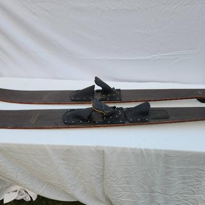 Sale Photo Thumbnail #254: Mach 1 Special wooden water skis featuring original rubber bindings labeled 'FORMULA S.' The skis exhibit a natural wood finish with 'Mach 1 Special' printed on the top. Suitable for water sports enthusiasts and collectors. Condition suggests prior use wi