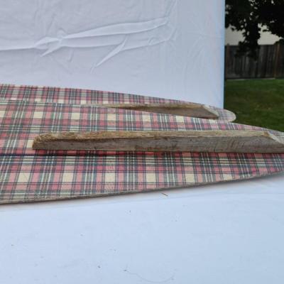 Sale Photo Thumbnail #263: Vintage water skis crafted from wood, featuring a distinctive plaid pattern on the surface. The skis are equipped with metal bindings and black foot straps. Visible wear is present, including scratches and marks consistent with use and age. The underside 
