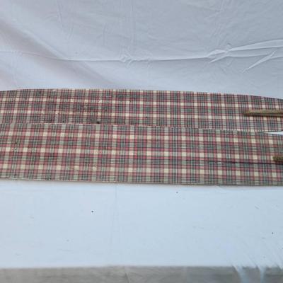 Sale Photo Thumbnail #262: Vintage water skis crafted from wood, featuring a distinctive plaid pattern on the surface. The skis are equipped with metal bindings and black foot straps. Visible wear is present, including scratches and marks consistent with use and age. The underside 